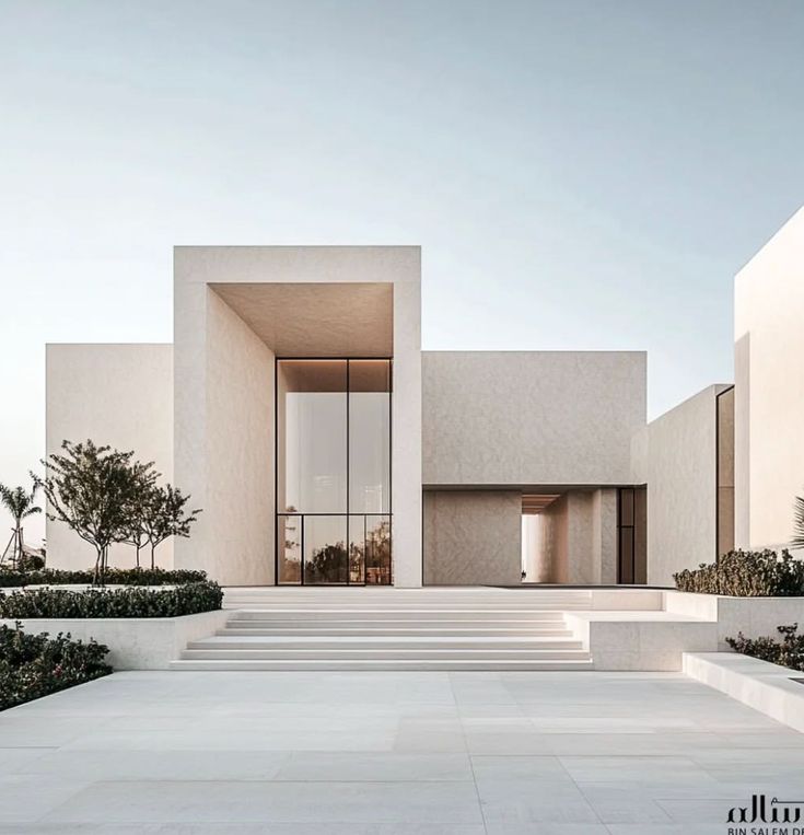Villa contemporaine minimaliste avec façade en béton et grandes ouvertures vitrées